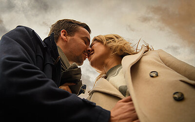 A couple on a winter walk during a romantic getaway at the Hotel Winzer