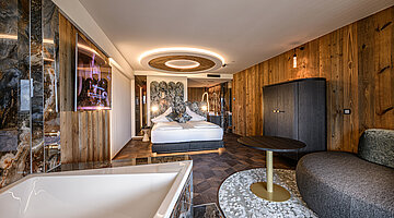 Kuschelnest Junior Suite with Whirlpool Bath Kuschelnest Junior Suite at Hotel Winzer with private whirlpool bath, double bed and a cosy living area for two