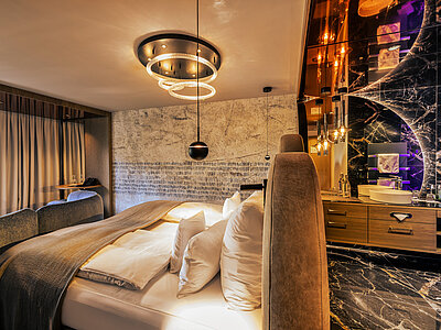 A cosy bed in a Spa Deluxe double room at the Hotel Winzer