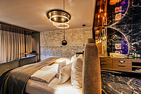A cosy bed in a Spa Deluxe double room at the Hotel Winzer