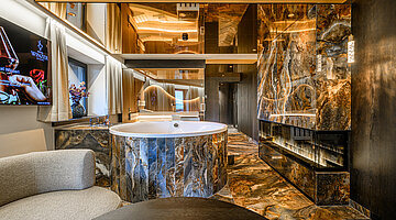 Private Spa mit Whirlpool und Kamin Private Spa der Secret Love Suite im Hotel Winzer mit Whirlpool, modernem Kamin und edlen Natursteinoberflächen